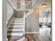 Bright open foyer with white staircase and engineered wood floors at 9707 Kings Canyon Pl, Tampa, FL 33634