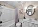 Bathroom featuring a shower-tub combo and a vanity with a decorative mirror at 1000 W Horatio St # 129, Tampa, FL 33606
