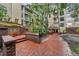 Inviting courtyard entrance featuring brick pathway and lush landscaping leading to the building's entrance at 1000 W Horatio St # 129, Tampa, FL 33606