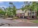 Condo building exterior featuring brick and siding with mature trees and covered parking at 1000 W Horatio St # 129, Tampa, FL 33606