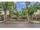 Hyde Park Place entrance with lush landscaping, mature trees and pleasant signage at 1000 W Horatio St # 129, Tampa, FL 33606