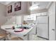 Bright kitchen featuring white cabinets, a breakfast bar, and modern appliances at 1000 W Horatio St # 129, Tampa, FL 33606