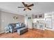 Open-concept living area with hardwood floors and view into adjacent kitchen at 1000 W Horatio St # 129, Tampa, FL 33606