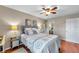 Cozy main bedroom with a queen-sized bed, ceiling fan, and mirrored nightstands at 1000 W Horatio St # 129, Tampa, FL 33606