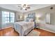 Comfortable bedroom with a queen bed, ceiling fan, and a large window at 1000 W Horatio St # 129, Tampa, FL 33606