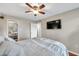 Comfortable bedroom with queen bed, ceiling fan, mirrored closet, and wall-mounted TV at 1000 W Horatio St # 129, Tampa, FL 33606