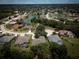 Beautiful aerial view showcasing a neighborhood with mature landscaping and a serene pond at 1137 Pristine Pl, Lutz, FL 33549