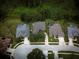 Aerial view showing homes with pools and mature trees in a suburban neighborhood at 1137 Pristine Pl, Lutz, FL 33549