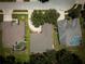Aerial view of a home with a circular driveway, mature landscaping and proximity to neighbor's pool at 1137 Pristine Pl, Lutz, FL 33549