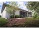 Backyard featuring a screened lanai, perfect for outdoor entertaining, with mature landscaping at 1137 Pristine Pl, Lutz, FL 33549