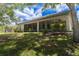 Spacious screened-in lanai, ceiling fans, and lush landscaping create a serene backyard retreat at 1137 Pristine Pl, Lutz, FL 33549