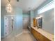 Bright bathroom featuring a double shower, decorative lighting, and vanity with drawers at 1137 Pristine Pl, Lutz, FL 33549