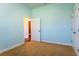 Carpeted bedroom with a door, window, and base molding at 1137 Pristine Pl, Lutz, FL 33549