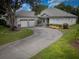 Charming single-story home with a spacious driveway and a well-manicured lawn at 1137 Pristine Pl, Lutz, FL 33549