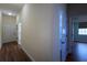 Hallway with wood floors provides access to bedrooms and storage areas at 1137 Pristine Pl, Lutz, FL 33549