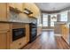 Well-lit kitchen features wood cabinets, a built-in microwave, and view to the dining area at 1137 Pristine Pl, Lutz, FL 33549