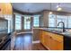 Open kitchen area boasts wood cabinets, black appliances, and an adjacent breakfast nook at 1137 Pristine Pl, Lutz, FL 33549