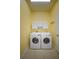 Laundry room with modern washer and dryer units at 1137 Pristine Pl, Lutz, FL 33549