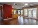 Open-concept living room featuring hardwood floors, large windows, and modern lighting at 1137 Pristine Pl, Lutz, FL 33549