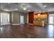 Bright and spacious living room featuring hardwood floors and a kitchen bar at 1137 Pristine Pl, Lutz, FL 33549