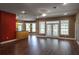 Open-concept living room featuring hardwood floors, large windows, and modern lighting at 1137 Pristine Pl, Lutz, FL 33549