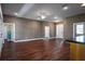 Bright and spacious living room featuring hardwood floors, and a kitchen bar at 1137 Pristine Pl, Lutz, FL 33549