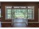 Living room with French doors opening to screened lanai with view of green backyard at 1137 Pristine Pl, Lutz, FL 33549