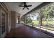 Large screened porch featuring tile floor, ceiling fan, and expansive view at 1137 Pristine Pl, Lutz, FL 33549