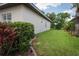 Spacious side yard with healthy green grass and lush landscaping along the home's exterior at 1137 Pristine Pl, Lutz, FL 33549