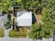 Aerial view of the home featuring a new metal roof and a partially fenced in yard with mature trees at 116 Hermes Rd, Venice, FL 34293