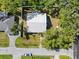Aerial view of the home featuring a new metal roof and a partially fenced in yard with mature trees at 116 Hermes Rd, Venice, FL 34293
