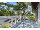 Backyard deck with railing and trees behind the backyard fence at 116 Hermes Rd, Venice, FL 34293