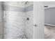 Shower with marble and subway tile accents featuring brushed silver fixtures in this en-suite bath at 116 Hermes Rd, Venice, FL 34293