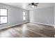 Spacious bedroom with neutral paint, wood-look flooring, and double windows for natural light at 116 Hermes Rd, Venice, FL 34293