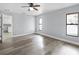 This bedroom provides views to an en-suite bath and the kitchen area. There is wood-look flooring throughout at 116 Hermes Rd, Venice, FL 34293