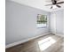 Light bright bedroom with hardwood floors, ceiling fan, and natural light from the window at 116 Hermes Rd, Venice, FL 34293
