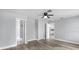 Bedroom with wood-look flooring provides doorways to an en-suite bath and kitchen at 116 Hermes Rd, Venice, FL 34293