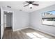 Bright bedroom with hardwood floors, ceiling fan, and natural light from the windows at 116 Hermes Rd, Venice, FL 34293