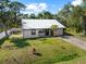 Front exterior featuring a new metal roof and fenced yard at 116 Hermes Rd, Venice, FL 34293