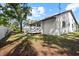View of the home's exterior with a white fence, white siding, and wood deck at 116 Hermes Rd, Venice, FL 34293