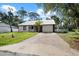 Charming single-story home with a metal roof, fresh white siding, and attached two-car garage at 116 Hermes Rd, Venice, FL 34293