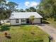 Front exterior featuring a new metal roof and fenced yard at 116 Hermes Rd, Venice, FL 34293