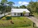 Front exterior featuring a new metal roof and fenced yard at 116 Hermes Rd, Venice, FL 34293