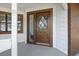 Close-up of the front door with decorative glass and contrasting trim, complemented by brick accents at 116 Hermes Rd, Venice, FL 34293