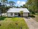 Charming single-story home featuring a metal roof, a front yard, and a single car garage at 116 Hermes Rd, Venice, FL 34293