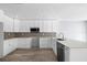 Modern kitchen featuring stainless appliances, white cabinets, and a large kitchen island at 116 Hermes Rd, Venice, FL 34293