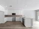 Well-lit kitchen featuring white cabinets, stainless appliances, and a large kitchen island at 116 Hermes Rd, Venice, FL 34293