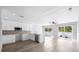 Open concept kitchen with granite countertops, stainless steel appliances, and access to the patio at 116 Hermes Rd, Venice, FL 34293