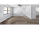 Bright living room featuring gray walls, modern ceiling fan, and beautiful wood-look flooring at 116 Hermes Rd, Venice, FL 34293