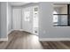 Bright living room with modern flooring, neutral paint, and natural light from the front door and windows at 116 Hermes Rd, Venice, FL 34293